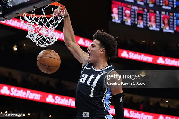 ATLANTA, GEORGIA - FEBRUARY 12: Jalen Johnson #1 of the Atlanta Hawks dunks against Coby White #0 of the Chicago Bulls during the first quarter at State Farm Arena on February 12, 2024 in Atlanta, Georgia. NOTE TO USER: User expressly acknowledges and agrees that, by downloading and/or using this photograph, user is consenting to the terms and conditions of the Getty Images License Agreement. (Photo by Kevin C. Cox/Getty Images)