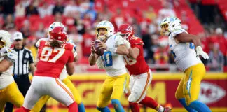 KANSAS CITY, MISSOURI - OCTOBER 18: George Karlaftis #56 of the Kansas City Chiefs sacks Justin Herbert #10 of the Los Angeles Chargers in the fourth quarter of a game at Arrowhead Stadium on October 18, 2026 in Kansas City, Missouri. (Photo by Jamie Squire/Getty Images)