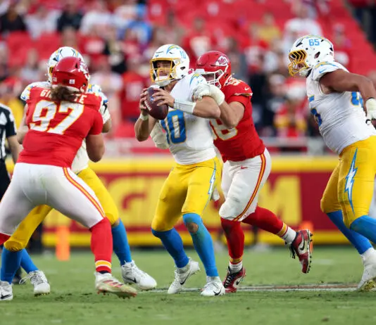 KANSAS CITY, MISSOURI - OCTOBER 18: George Karlaftis #56 of the Kansas City Chiefs sacks Justin Herbert #10 of the Los Angeles Chargers in the fourth quarter of a game at Arrowhead Stadium on October 18, 2026 in Kansas City, Missouri. (Photo by Jamie Squire/Getty Images)