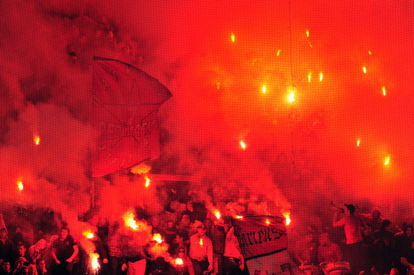 Supporters of Olympiakos light flares an