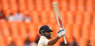 Virat Kohli celebrating scoring 150 runs.