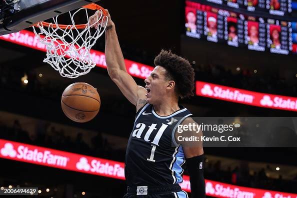 ATLANTA, GEORGIA - FEBRUARY 12: Jalen Johnson #1 of the Atlanta Hawks dunks against Coby White #0 of the Chicago Bulls during the first quarter at State Farm Arena on February 12, 2024 in Atlanta, Georgia. NOTE TO USER: User expressly acknowledges and agrees that, by downloading and/or using this photograph, user is consenting to the terms and conditions of the Getty Images License Agreement. (Photo by Kevin C. Cox/Getty Images)